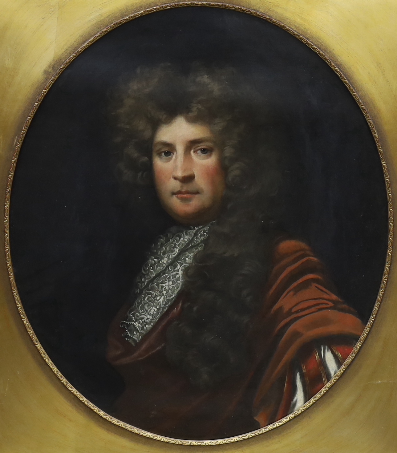 English School, oil on canvas, Portrait of an early 18th century gentleman wearing a wig and lace cravat, oval, 73 x 62cm, gilt frame